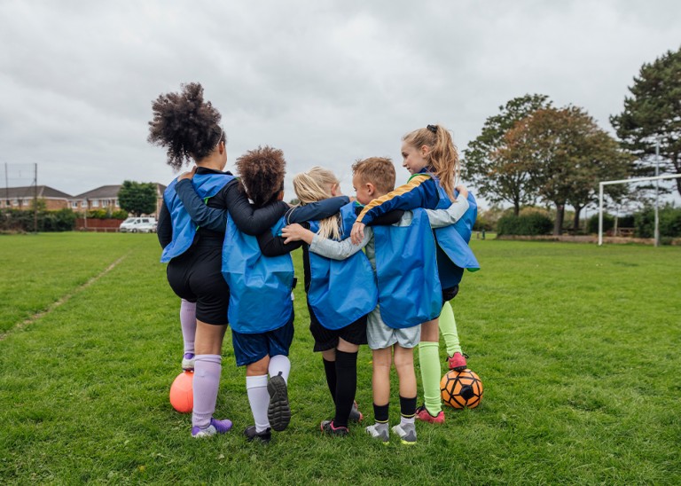 Kids playing football. © Getty  