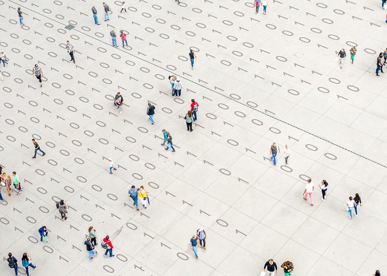 Crowd walking over binary code © Getty Images/Orbon Alija